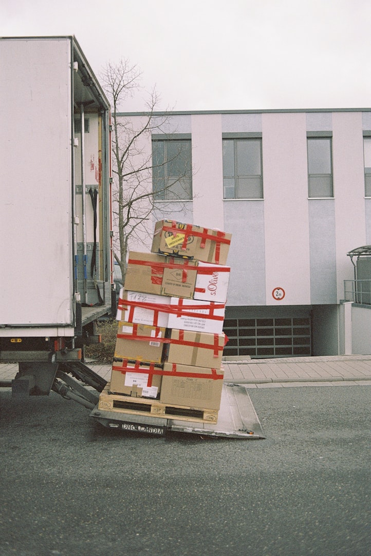 a man in a yellow safety vest and green gloves unloads a garbage bag